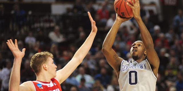 Mar 21, 2015; Portland, OR, USA; Georgetown Hoyas center L.J. Peak (0) shoots the basketball against Utah Utes forward Jakob Poeltl (42) during the first half in the third round of the 2015 NCAA Tournament at Moda Center. Mandatory Credit: Godofredo Vasquez-USA TODAY Sports