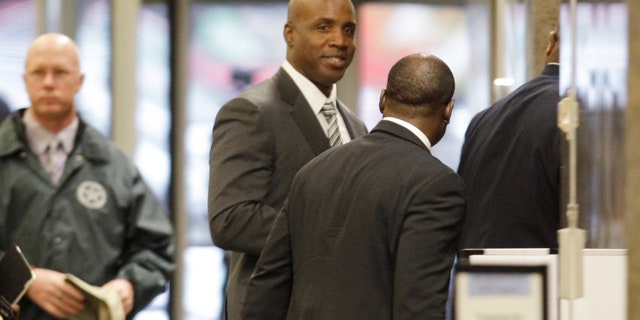 March 23: Barry Bonds goes through security as he arrives at the federal courthouse for his criminal trial in San Francisco.