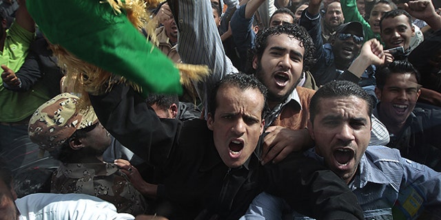 March 23: In this image taken during an organized trip by the Libyan authorities, Libyan supporters of Moammar Gadhafi, some of whom came from Tripoli, take part in a staged demonstration in Ban-Waled, home of the Warfallah tribe, 100 miles south east of Tripoli.