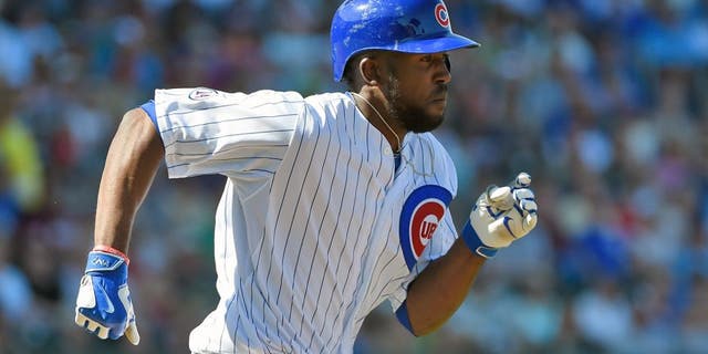 MESA, AZ - MARCH 09: Dexter Fowler #24 of the Chicago Cubs runs to first base after hitting a single against the San Diego Padres on March 9, 2015 in Mesa, Arizona. (Photo by Lisa Blumenfeld/Getty Images)