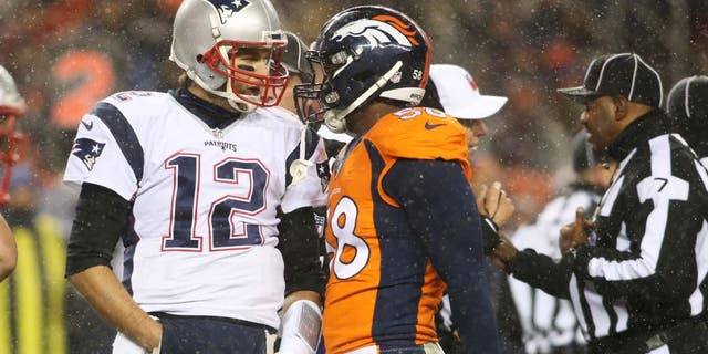 New England Patriots quarterback Tom Brady (12) and Denver Broncos outside linebacker Von Miller (58) have words during the first half at Sports Authority Field at Mile High. Mandatory Credit: