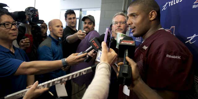 May 27, 2015: Michael Sam, newly signed defensive end for the Montreal Alouettes CFL football team talks to the media following his first day of rookie training camp in Sherbrooke, Quebec .