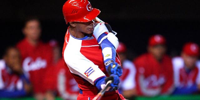 MEXICO CITY - MARCH 10: Second baseman Hector Olivera #28 of Cuba blasts a line drive for an out during the Pool B, game four against Australia in the first round of the 2009 World Baseball Classic at Foro Sol Stadium in Mexico City, Mexico, Monday March 10, 2009. Cuba defeated Australia 5-4. (Photo by Paul Spinelli/WBCI/MLB Photos via Getty Images)