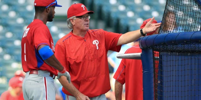 Interim manager Pete Mackanin #45 of the Philadelphia Phillies talks with Domonic Brown #9 during warm ups before their game against the Milwaukee Brewers at Miller Field on August 15, 2015 in Milwaukee, Wisconsin. The Brewers defeated the Phillies 4-2. (Photo by John Konstantaras/Getty Images)