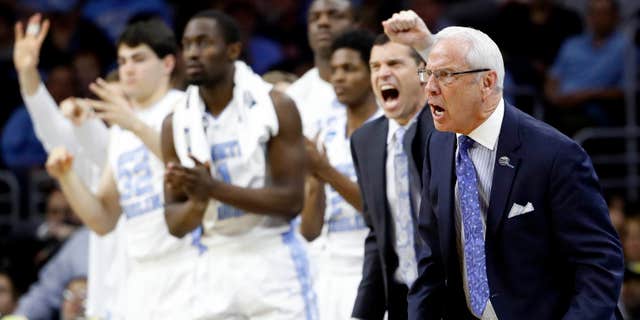 North Carolina coach Roy Williams and players react during the second half of the team's college basketball game against Indiana in the regional semifinals of the men's NCAA Tournament, early Saturday, March 26, 2016, in Philadelphia.