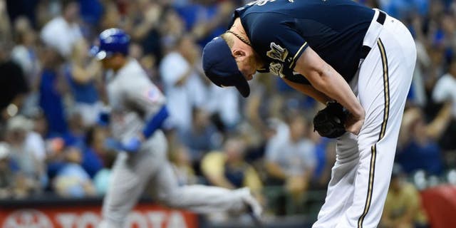 Jul 30, 2015; Milwaukee, WI, USA; Milwaukee Brewers pitcher Will Smith (13) reacts after giving up a 3-run homer to Chicago Cubs first baseman Anthony Rizzo (44) in the eighth inning at Miller Park. Smith was charged with the loss as The Cubs won 5-2. Mandatory Credit: Benny Sieu-USA TODAY Sports