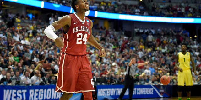Oklahoma guard Buddy Hield celebrates after scoring during the first half of an NCAA college basketball game against Oregon in the regional finals of the NCAA Tournament, Saturday, March 26, 2016, in Anaheim, Calif.
