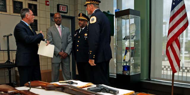 Sept. 3, 2013: Chicago Police Superintendent Garry McCarthy (L) speaks to First Deputy Superintendent Al Wysinger (2nd L), Deputy Chief of Area Central Patrol Eddie Johnson (2nd R) and Bureau of Patrol Chief Wayne Gulliford after a news conference on Chicago Police having seized more than 4,800 illegal firearms in 2013 in Chicago, Illinois,