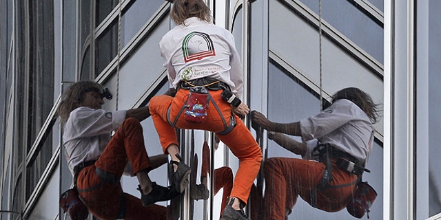 March 28: French Spider man Alain Robert climbs up Burj Khalifa, the world's tallest tower in Dubai, United Arab Emirates.