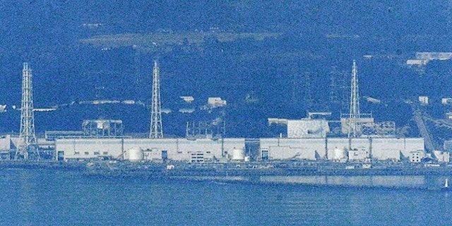 March 29: Only Unit 2 is covered with white concrete housing, seen on left of an iron tower on right, at the stricken Fukushima Dai-ichi nuclear power plant in Okumamachi, Fukushima prefecture.