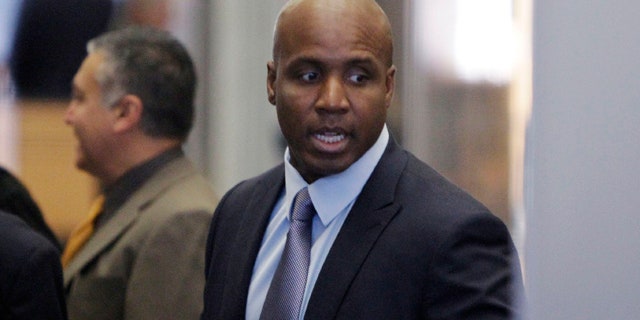March 28: Barry Bonds goes through security at a federal courthouse as his trial resumes in San Francisco.