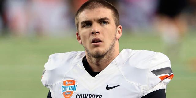 Jan 3, 2014; Arlington, TX, USA; Oklahoma State Cowboys quarterback J.W. Walsh (4) before the game against the Missouri Tigers in the 2014 Cotton Bowl at AT&T Stadium. Missouri won 41-31. Mandatory Credit: Kevin Jairaj-USA TODAY Sports