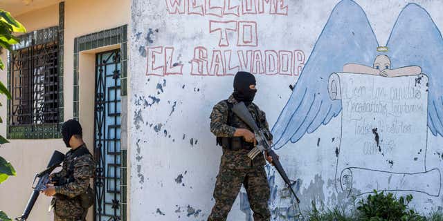 FILE - In this Aug. 31, 2015 file photo, soldiers guard a corner in a gang-controlled neighborhood in Ilopango, El Salvador.