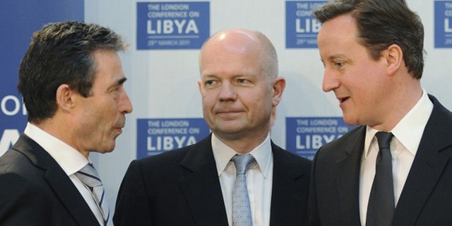 March 29: Britain's Prime Minister David Cameron (R) speaks to NATO Secretary General Anders Fogh Rasmussen (L), watched by Foreign Secretary William Hague, at the Foreign & Commonwealth Office in London.