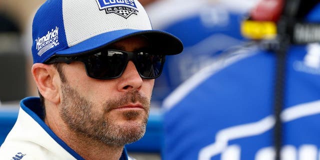 AVONDALE, AZ - MARCH 11: Jimmie Johnson, driver of the #48 Lowe's Pro Services Chevrolet, talks to a crew member on the grid during qualifying for the NASCAR Sprint Cup Series Good Sam 500 at Phoenix International Raceway on March 11, 2016 in Avondale, Arizona. (Photo by Daniel Shirey/Getty Images)