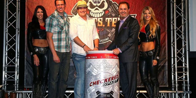 DALLAS, TEXAS - MARCH 30: Texas Motor Speedway President Eddie Gossage and Scott Lindsey, owner of Audacity Brew House in Denton, Texas unveil the new Checkered Past beer during the Texas Motor Speedway Media Day at Gilley's Dallas on March 30, 2016 in Dallas, Texas. (Photo by Sarah Crabill/Getty Images for Texas Motor Speedway)