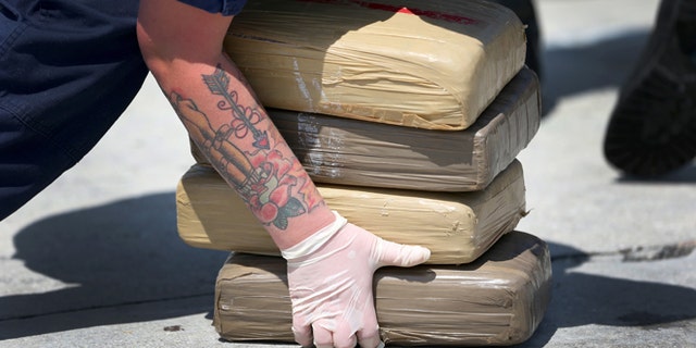 MIAMI BEACH, FL - MAY 09: A U.S. Coast Guard crew member off loads blocks of marijuana from the Paul Clark one of the Coast Guard's newest fast-response cutters on May 9, 2014 in Miami Beach, Florida. The U.S. Coast Guard used two of the new fast-response cutters to seize the more than $3 million in drugs earlier this month on the Caribbean Sea in separate interdictions just a day apart from each other. (Photo by Joe Raedle/Getty Images)