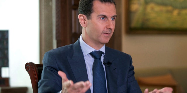 FILE -- In this Wednesday, Sept. 21, 2016 file photo released by the Syrian Presidency, Syrian President Bashar Assad speaks to The Associated Press at the presidential palace in Damascus, Syria.