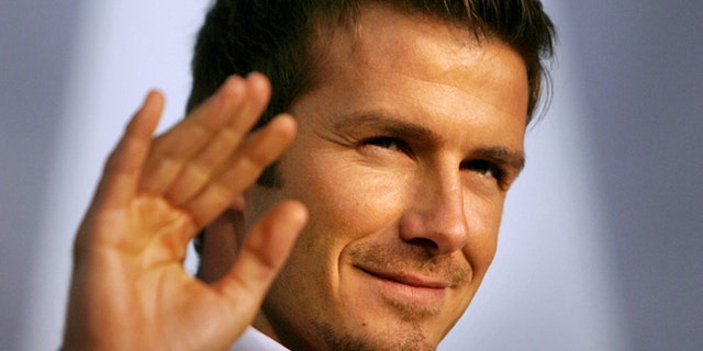 FILE - In this Dec. 29, 2006 file photo, Real Madrid soccer star David Beckham waves to fans during a promotional event in Tokyo. Beckham says he is retiring from soccer at the end of the season. The 38-year-old Beckham recently won a league title in a fourth country with Paris Saint-Germain. He has become a global superstar since starting his career at Manchester United. (AP Photo/David Guttenfelder, File)