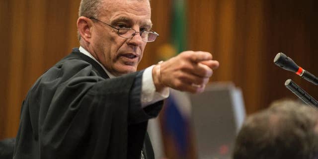 FILE -- In this Thursday, Aug. 7, 2014 file photo, state prosecutor Gerrie Nel gestures, during the Oscar Pistorius murder trial in Pretoria, South Africa. Nel announced Tuesday, Jan. 31, 2017 that he has quit his position and will head AfriForum's new private prosecuting unit, which will target state officials and politicians suspected of graft. (AP Photo/Mujahid Safodien, Pool, File)