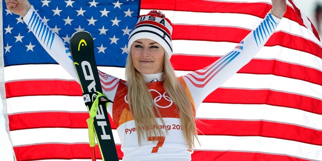 Bronze medal winner Lindsey Vonn, of the United States, celebrates during the flower ceremony for the women's downhill at the 2018 Winter Olympics in South Korea, Feb. 21, 2018.