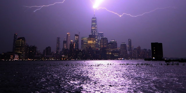 Lightning lights up the sky over Lower Manhattan as a bolt strikes One World Trade Center on Aug. 22, 2017, as seen from Hoboken, New Jersey.