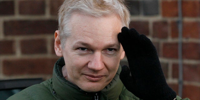Dec. 17, 2010: Julian Assange, head of WikiLeaks, gestures as he gets back into a car at Beccles Police Station in Suffolk, England, after complying with bail conditions.