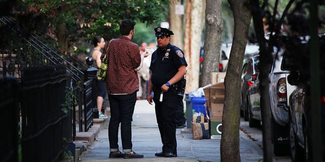 NEW YORK, NY - JUNE 10: Police officers are seen by a crime scene where three people were shot on June 10, 2015 in the Gowanus area of the Brooklyn Borough of New York City. In an effort to combat the rise in murders and shootings, hundreds of additional New York City Police Officers will begin walking city streets as part of an aggressive NYPD initiative called "Summer All Out." About 330 officers will be taken off of administrative duty to patrol the streets in some of the city's most violent neighborhoods. (Photo by Spencer Platt/Getty Images)