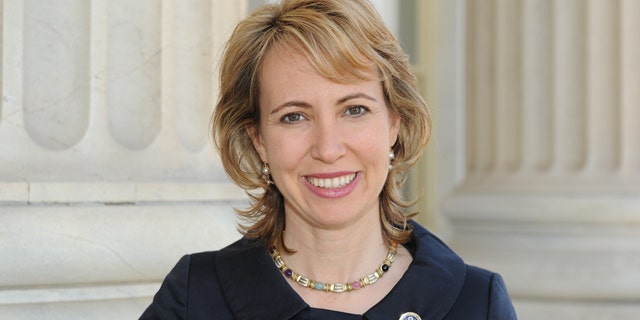 Rep. Gabrielle Giffords stood up in her hospital room Wednesday and looked out her window