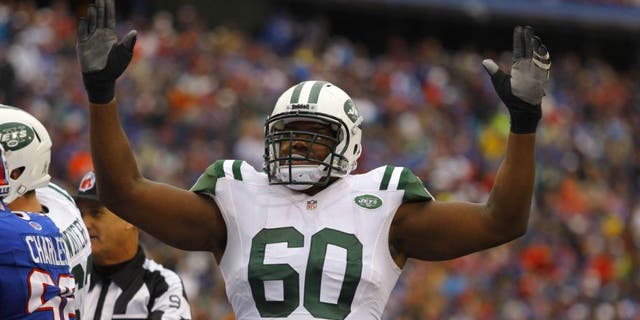 Nov 17, 2013; Orchard Park, NY, USA; New York Jets tackle D'Brickashaw Ferguson (60) celebrates a touchdown during the second half against the Buffalo Bills at Ralph Wilson Stadium. Bills beat the Jets 37-14. Mandatory Credit: Timothy T. Ludwig-USA TODAY Sports