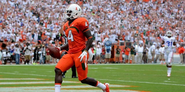 Sep 7, 2013; Miami Gardens, FL, USA; Miami Hurricanes wide receiver Phillip Dorsett (4) scores untouched against the Florida Gators during the first half of the game at Sun Life Stadium. Mandatory Credit: Brad Barr-USA TODAY Sports