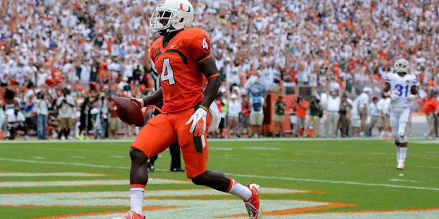 Sep 7, 2013; Miami Gardens, FL, USA; Miami Hurricanes wide receiver Phillip Dorsett (4) scores untouched against the Florida Gators during the first half of the game at Sun Life Stadium. Mandatory Credit: Brad Barr-USA TODAY Sports