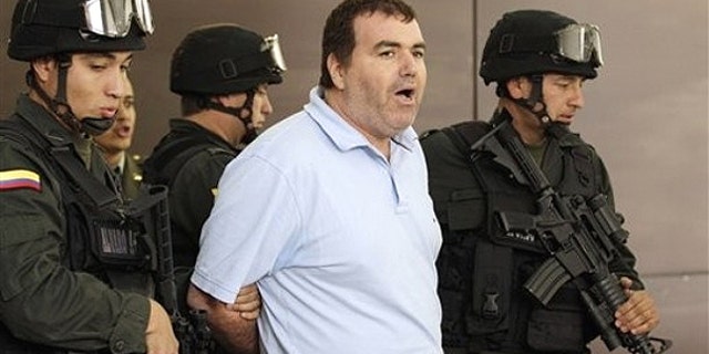 Aug. 20, 2010: Police escort suspected drug trafficker Walid Makled Garcia, from Venezuela, center, during a press conference at police headquarters in Bogota, Colombia.