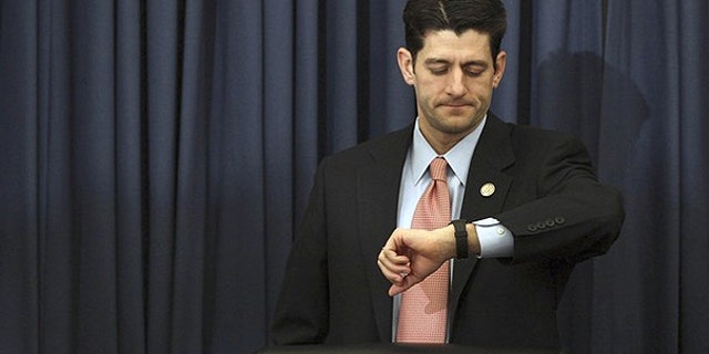 Feb. 15: U.S. House Budget Committee Chairman Paul Ryan (R-WI) checks his watch as Director of the White House's Office of Management and Budget, Jacob Lew arrives late to testify at a House Budget Committee hearing on Capitol Hill in Washington.