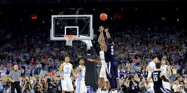 HOUSTON, TEXAS - APRIL 04: Kris Jenkins #2 of the Villanova Wildcats shoots the game-winning three pointer to defeat the North Carolina Tar Heels 77-74 in the 2016 NCAA Men's Final Four National Championship game at NRG Stadium on April 4, 2016 in Houston, Texas. (Photo by Ronald Martinez/Getty Images)