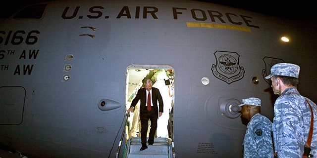 April 6: U.S. Defense Secretary Robert Gates steps off of his C-17 airplane before being met by U.S. Army Gen. Lloyd Austin, center, commanding general of U.S. Forces in Iraq, in Baghdad, Iraq.