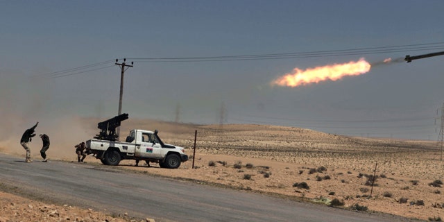 April 5: Libyan rebels shell pro Qaddafi positions just outside Brega, Libya.