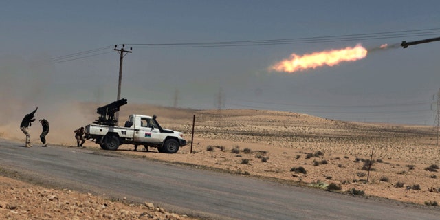 April 5: Libyan rebels shell pro Qaddafi positions just outside Brega, Libya.