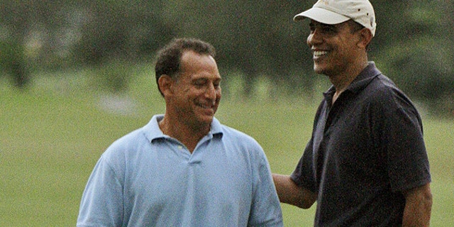 In this Dec. 31, 2009 file photo, President Obama, right, laughs with Bobby Titcomb on the 18th green as they play golf at Mid Pacific Country Club in Kailua, Hawaii.