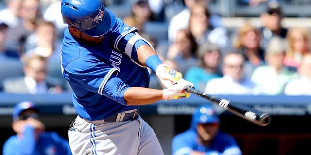 NEW YORK, NY - APRIL 06: Edwin Encarnacion #10 of the Toronto Blue Jays hits a two run homer in the third inning against the New York Yankees during Opening Day on April 6, 2015 at Yankee Stadium in the Bronx borough of New York City. (Photo by Elsa/Getty Images)