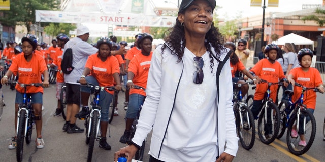 This Aug. 22, 2009, file photo shows Gloria James, mother of basketball star LeBron James, watching a group of bike riders as she waits to start another group of riders at the "King for Kids Bikeathon" in Akron, Ohio.