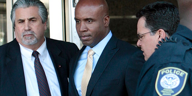 April 7: Former baseball player Barry Bonds, center, leaves federal court in San Francisco.
