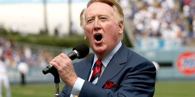 LOS ANGELES - APRIL 13: Dodgers broadcaster Vin Skully gives the call of "It's time for Dodger baseball!" during pregame ceremonies for the Los Angeles Dodgers home opener against the San Francisco Giants on April 13, 2009 at Dodger Stadiium in Los Angeles, California. (Photo by Stephen Dunn/Getty Images) *** Local Caption *** Vin Skully