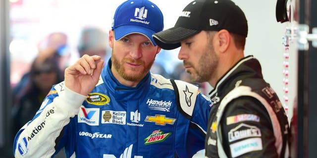Dale Earnhardt Jr., driver of the #88 Nationwide Chevrolet, speaks with Jimmie Johnson, driver of the #48 Kobalt Tools Chevrolet, in the garage during qualifying for the NASCAR XFINITY Series Boyd Gaming 300 at Las Vegas Motor Speedway on March 7, 2015 in Las Vegas, Nevada. (Photo by Robert Laberge/Getty Images)