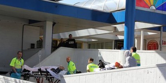 April 9: Injured people are carried out of a shopping mall after a shooting in Alpen aan den Rijn, Netherlands.