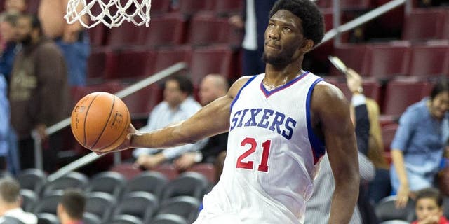 Apr 15, 2015; Philadelphia, PA, USA; Injured Philadelphia 76ers center Joel Embiid (21) dunks during warm ups before playing against the Miami Heat at Wells Fargo Center. Mandatory Credit: Bill Streicher-USA TODAY Sports