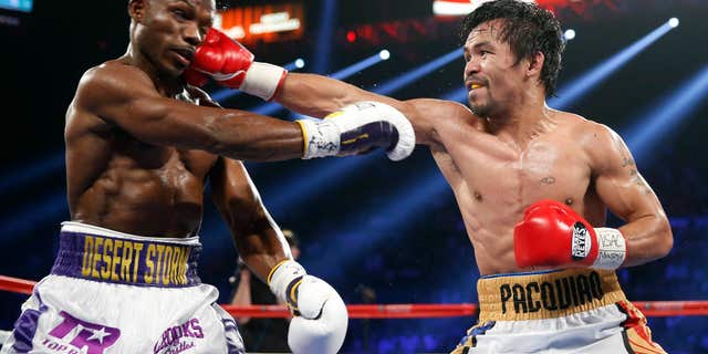 Manny Pacquiao, right, of the Philippines, hits Timothy Bradley during their WBO welterweight title boxing bout Saturday, April 9, 2016, in Las Vegas.