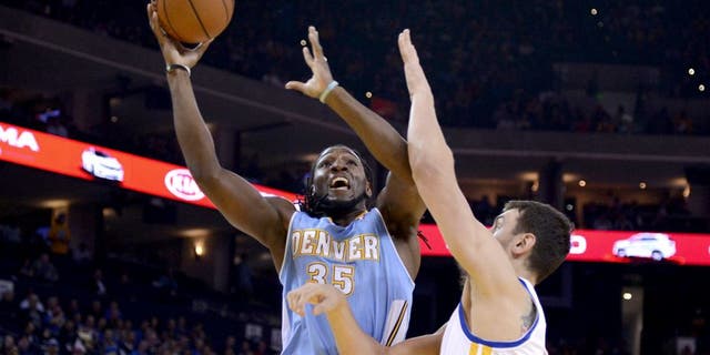 April 10, 2014; Oakland, CA, USA; Denver Nuggets forward Kenneth Faried (35) shoots the ball against Golden State Warriors center Andrew Bogut (12) during the first quarter at Oracle Arena. Mandatory Credit: Kyle Terada-USA TODAY Sports