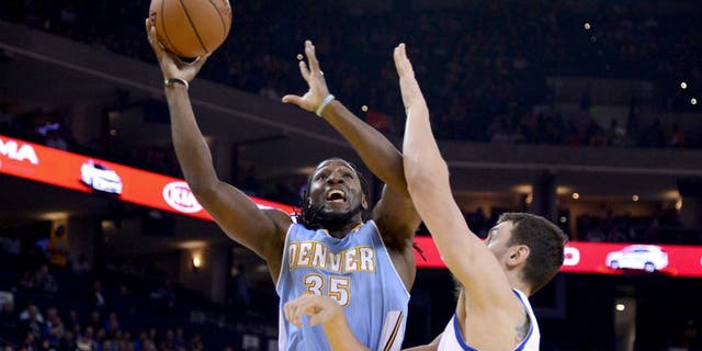 April 10, 2014; Oakland, CA, USA; Denver Nuggets forward Kenneth Faried (35) shoots the ball against Golden State Warriors center Andrew Bogut (12) during the first quarter at Oracle Arena. Mandatory Credit: Kyle Terada-USA TODAY Sports