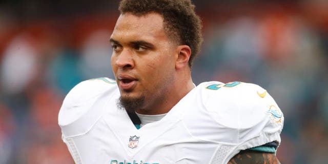 Nov 23, 2014; Denver, CO, USA; Miami Dolphins guard Mike Pouncey (51) before the game against the Denver Broncos at Sports Authority Field at Mile High. Mandatory Credit: Chris Humphreys-USA TODAY Sports